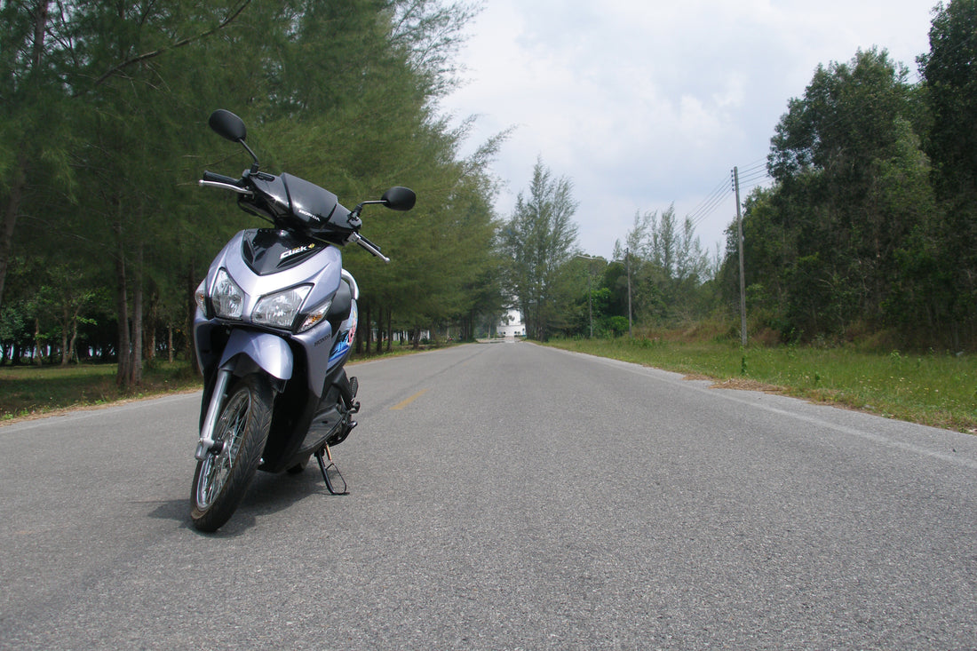 Honda Click scooter parked on a quiet road in Thailand