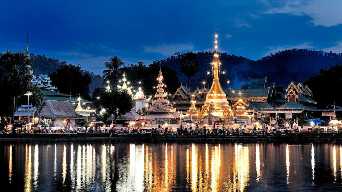 Wat Chong Klang and Wat Chong Kham in Mae Hong Son lit up at dusk and reflected in Chong Kham Lake