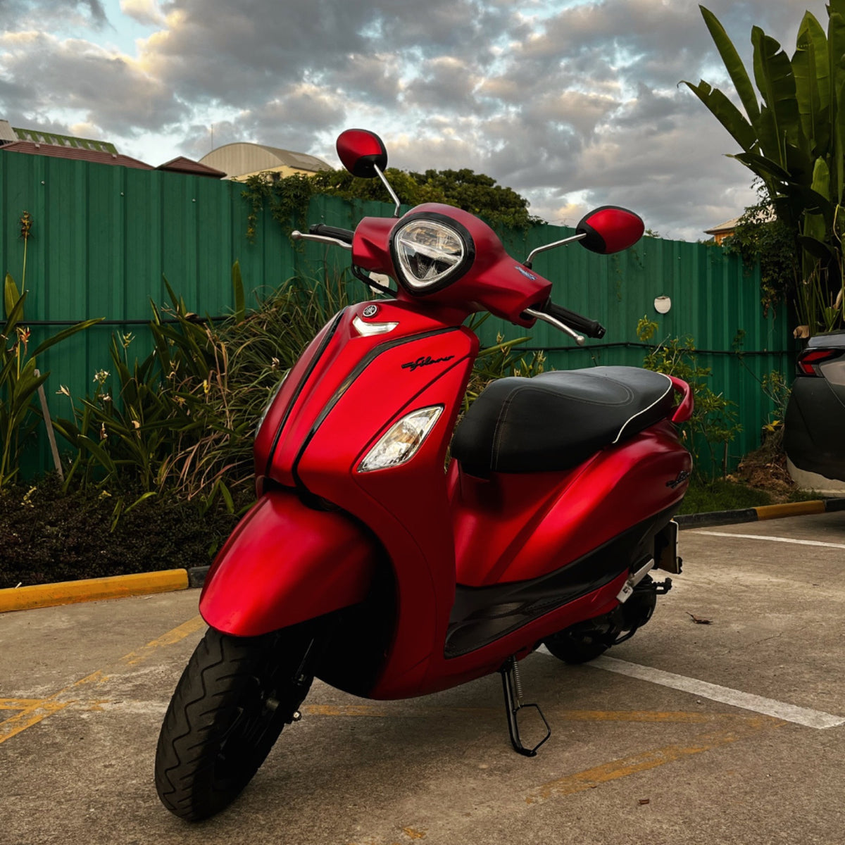 Fleet CNX red Yamaha Grand Filano under a cloudy sky